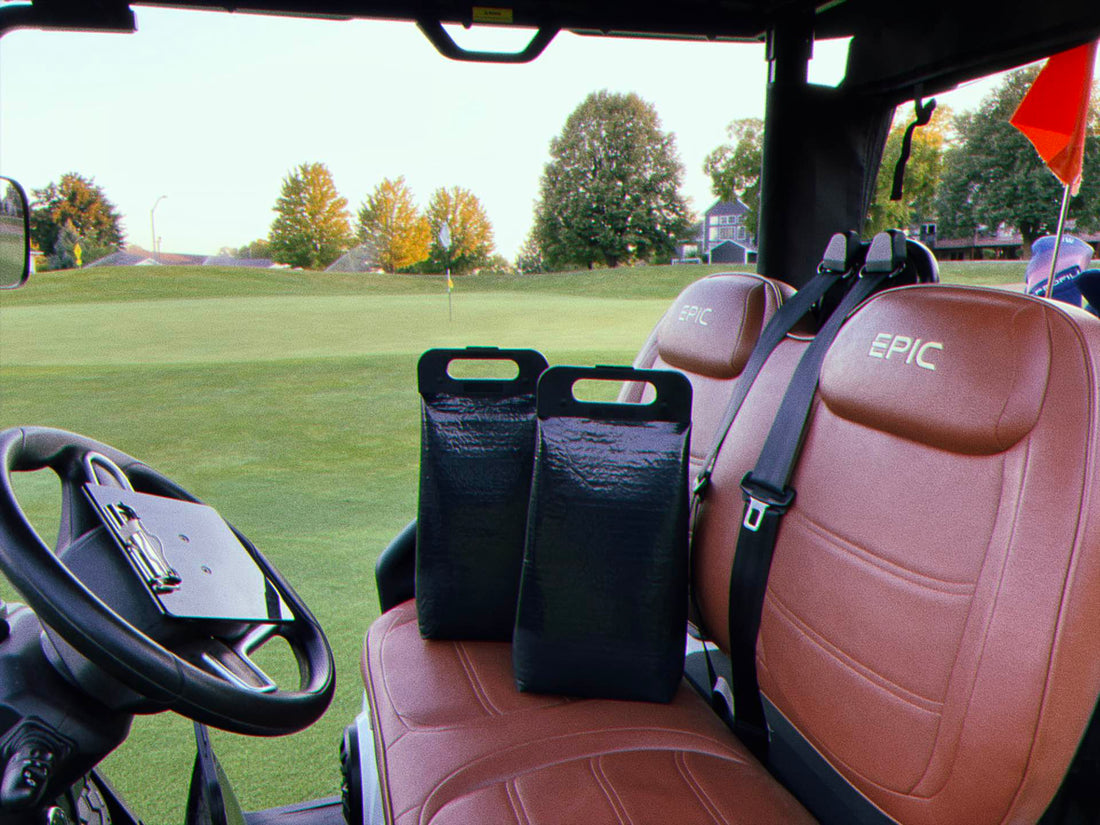Two cooler bags on the seat of a golf cart